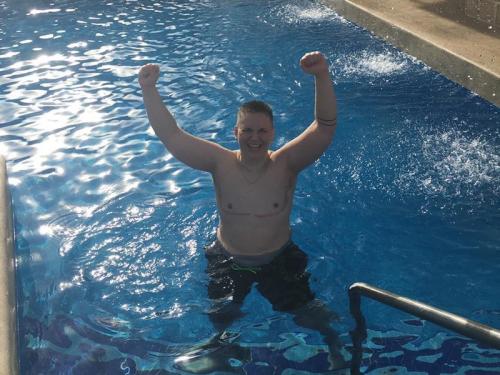 Kase stands triumphantly in pool