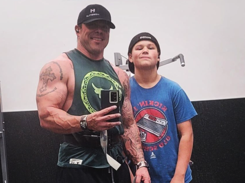 Colby shows off his physique with his son